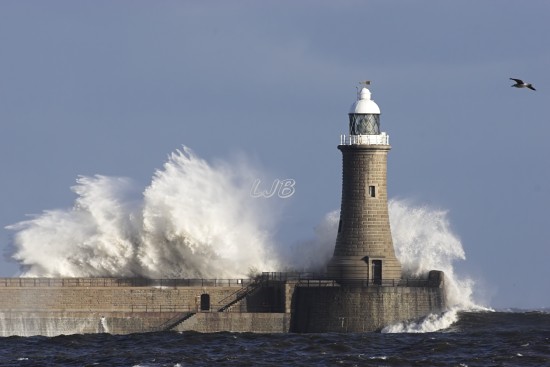 Waves breaking over Tynemouth Lighthouse, River Tyne North Pier.